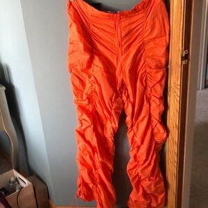 Bright orange parachute pants
